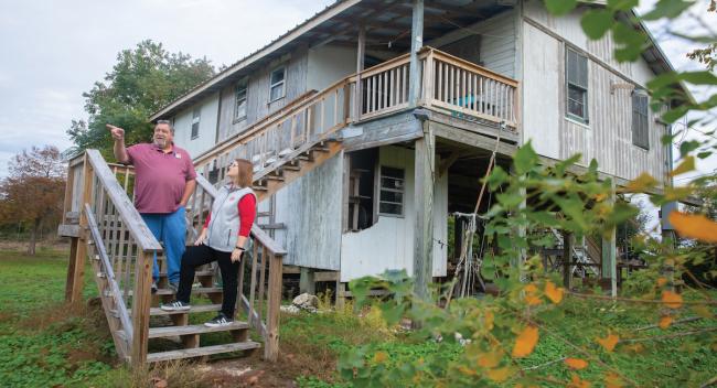 Deme Naquin, Jean Charles Choctaw Nation tribal chief, talks to Dr. Heather Stone at an abandoned house on Isle de Jean Charles.